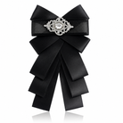 Brosa de dama din satin negru in forma de funda cu detalii pliatede 16 cm lungime si catarama centrala incrustata cu cristale.
