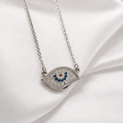 Colier statement din argint 925 rodiat cu pandantiv mare de 2 cm reprezentand simbolul Evil Eye, incrustat integral cu diamante CZ albe si albastre, imagine close up