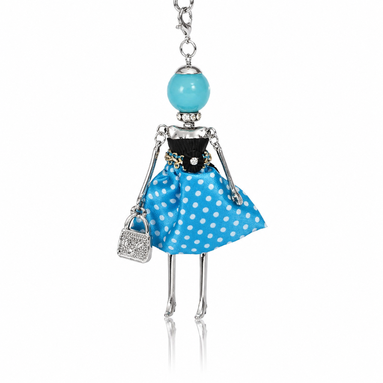 Colier lung din otel inoxidabil cu pandantiv papusica din colectia Bambole, rochita albastra cu buline albe, gentusa cu cristale si perla turcoaz.

